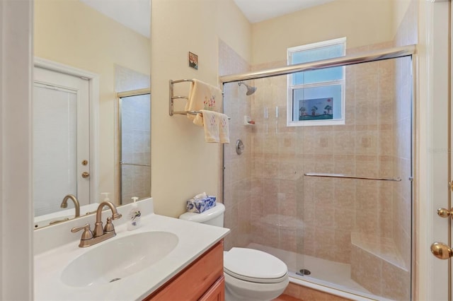 bathroom with vanity, an enclosed shower, and toilet