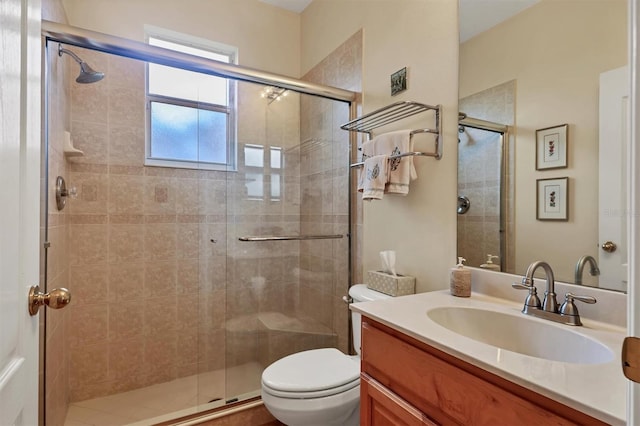 bathroom featuring an enclosed shower, vanity, and toilet