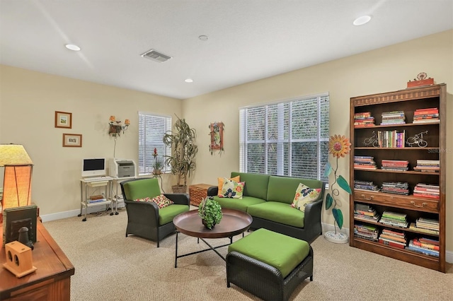 sitting room featuring light colored carpet