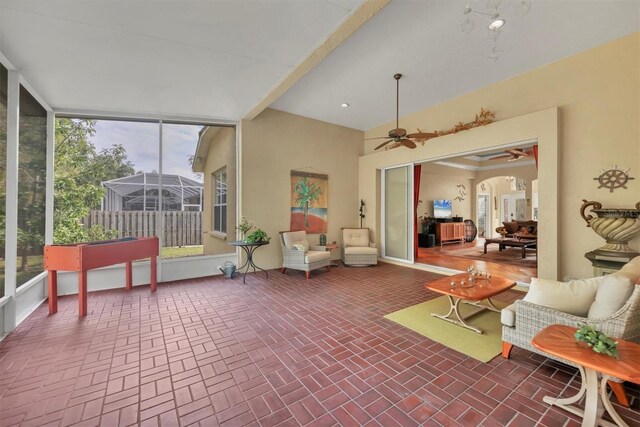 sunroom / solarium with plenty of natural light and ceiling fan