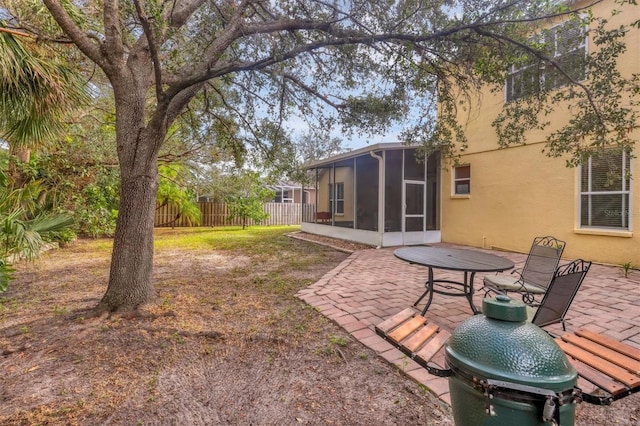 view of yard featuring a patio and a sunroom