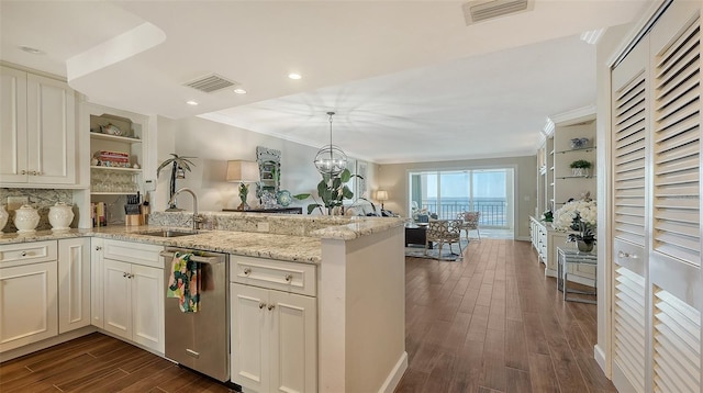 kitchen with dark wood-type flooring, sink, stainless steel dishwasher, kitchen peninsula, and a chandelier