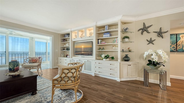 living area with dark hardwood / wood-style flooring, built in features, and ornamental molding