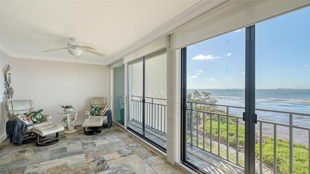 sunroom / solarium with a water view and ceiling fan