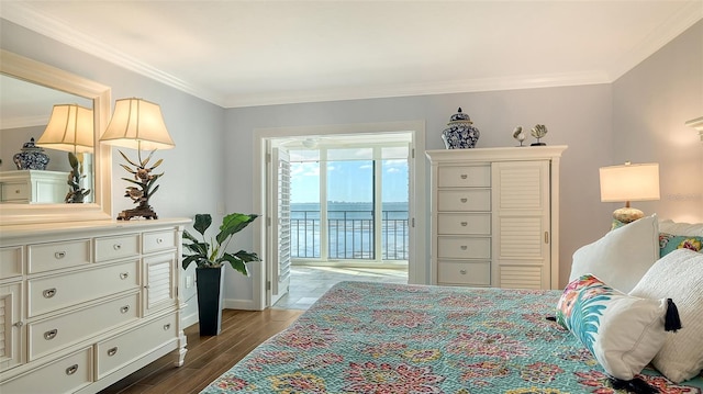 bedroom featuring access to exterior, a water view, and crown molding