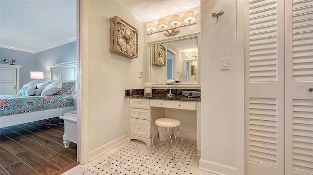 bathroom with crown molding, vanity, and wood-type flooring