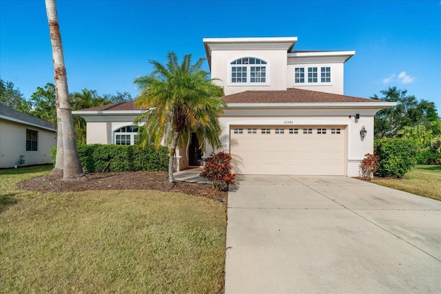 view of front facade with a front yard and a garage