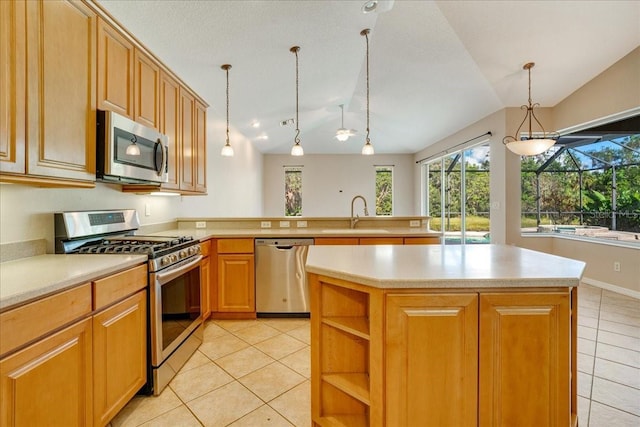 kitchen with sink, a center island, stainless steel appliances, pendant lighting, and lofted ceiling