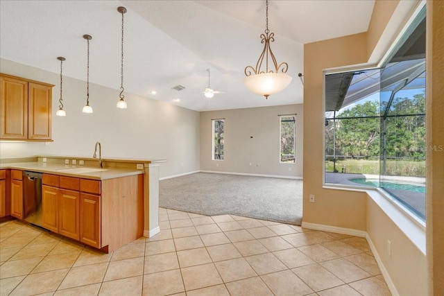 kitchen featuring sink, light tile patterned floors, pendant lighting, and stainless steel dishwasher