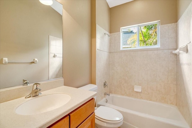 full bathroom with toilet, vanity, and tiled shower / bath