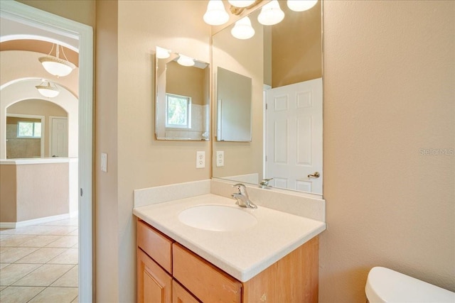 bathroom with tile patterned floors, vanity, and toilet