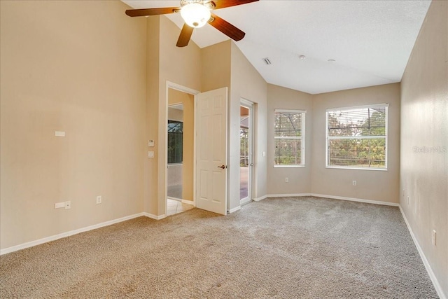 unfurnished bedroom featuring light colored carpet, high vaulted ceiling, and ceiling fan