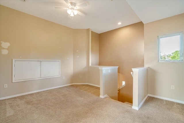 spare room with light carpet and ceiling fan