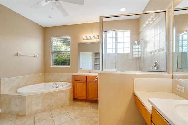 bathroom with tile patterned floors, plenty of natural light, shower with separate bathtub, and vanity