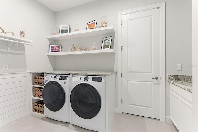 laundry area with light tile patterned flooring and washing machine and dryer