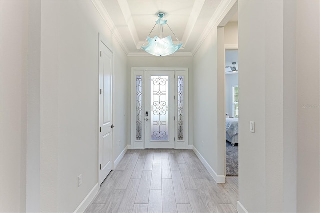 foyer entrance featuring crown molding and light wood-type flooring