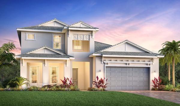 view of front of home with a garage and a yard