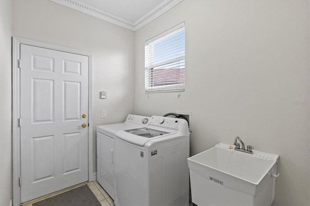 washroom with washing machine and dryer, sink, light tile patterned flooring, and crown molding