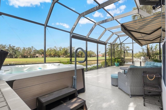 view of patio / terrace with a hot tub, a water view, and glass enclosure