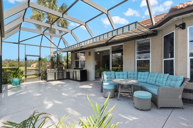 view of patio with area for grilling, a grill, and glass enclosure