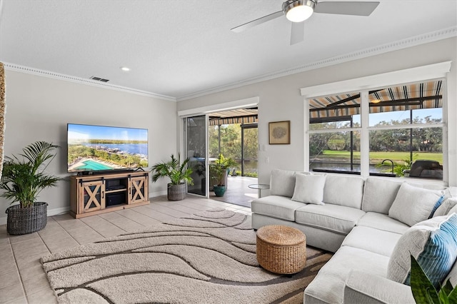 tiled living room with crown molding and ceiling fan