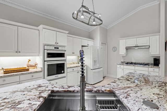 kitchen with lofted ceiling, white cabinetry, tasteful backsplash, white refrigerator with ice dispenser, and double wall oven