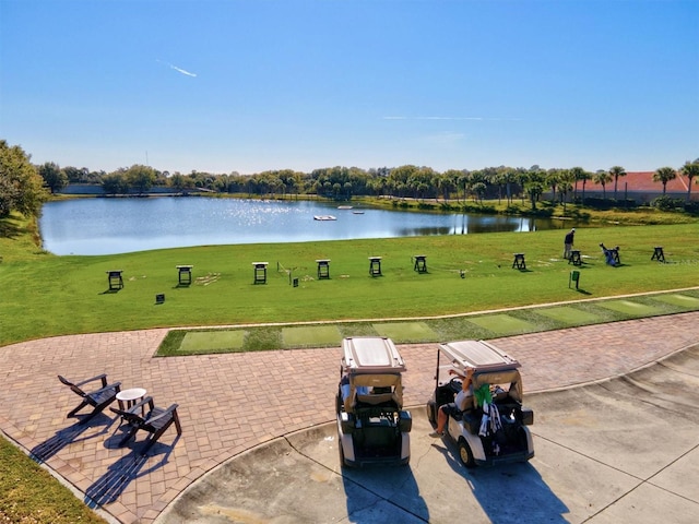 view of property's community with a yard and a water view