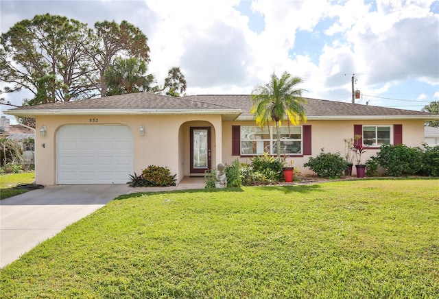 ranch-style house featuring a garage and a front yard