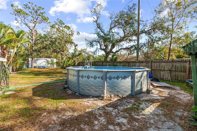 view of pool with a lawn