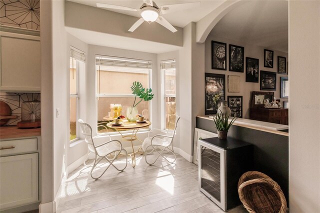 living area featuring light wood-type flooring and ceiling fan