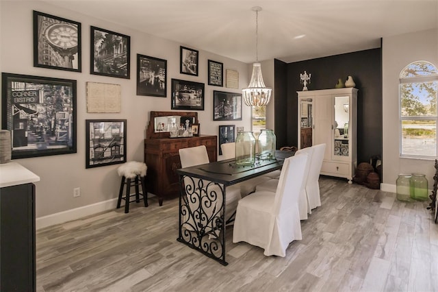 dining area featuring a notable chandelier and wood-type flooring