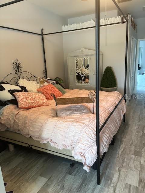 bedroom with wood-type flooring