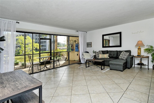 living room featuring light tile patterned floors and a textured ceiling