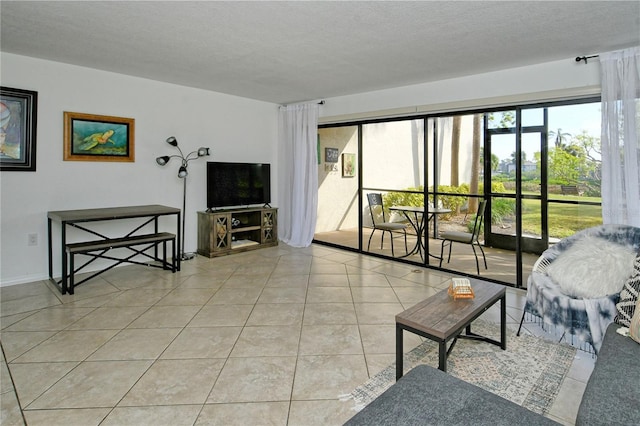 living room with light tile patterned floors and a textured ceiling