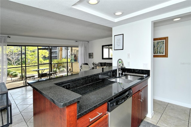 kitchen with dishwasher, sink, dark stone countertops, light tile patterned floors, and a textured ceiling