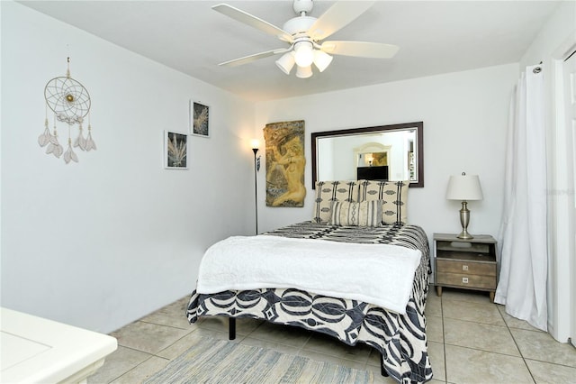 bedroom with ceiling fan and light tile patterned flooring