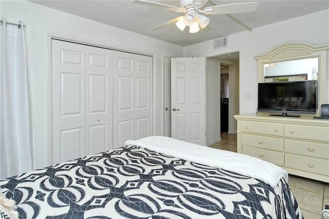 tiled bedroom with a closet and ceiling fan