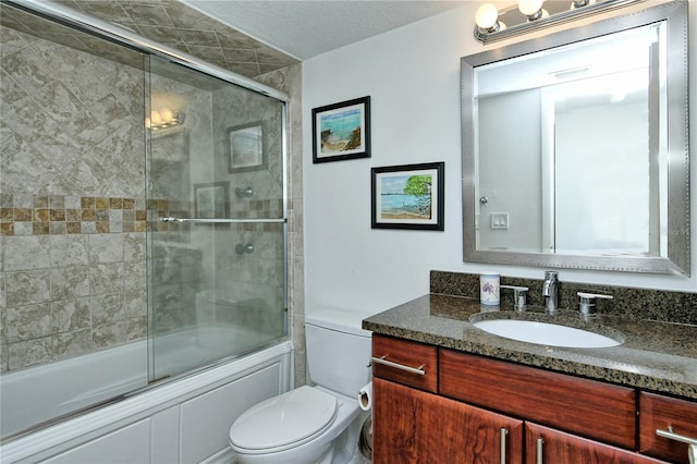 full bathroom with vanity, toilet, shower / bath combination with glass door, and a textured ceiling