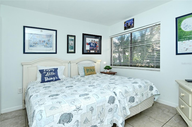 tiled bedroom featuring multiple windows