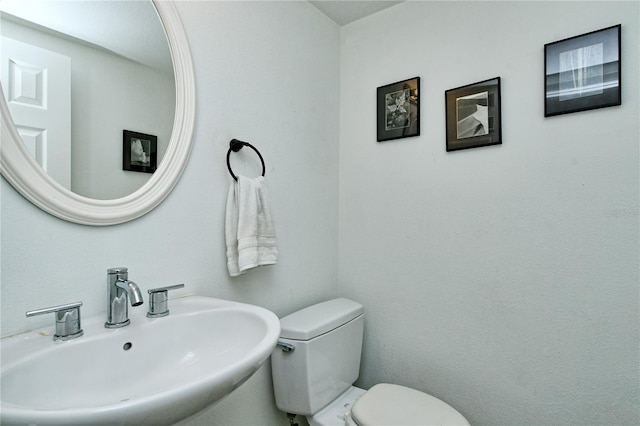 bathroom featuring toilet and sink