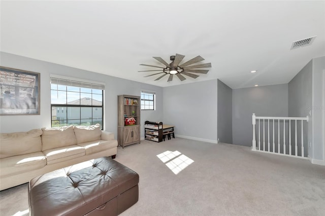 living room featuring ceiling fan and light colored carpet