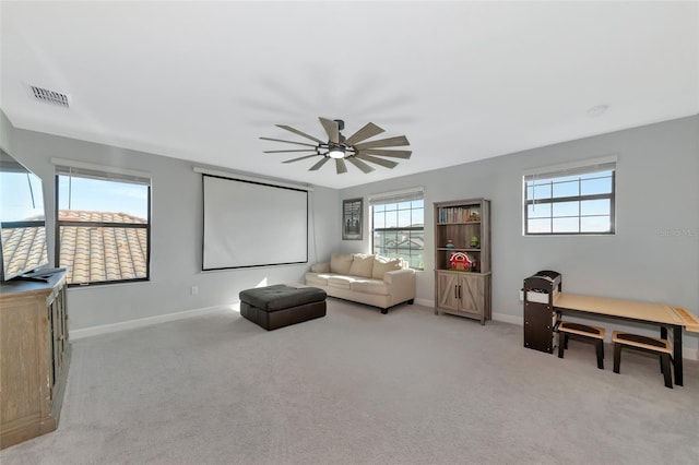 carpeted living room featuring ceiling fan