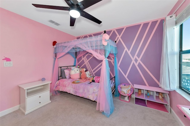 carpeted bedroom featuring ceiling fan and multiple windows