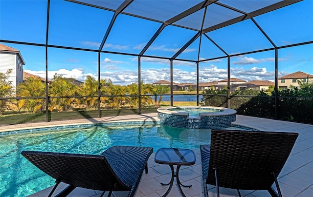 view of pool with a patio area, glass enclosure, and an in ground hot tub