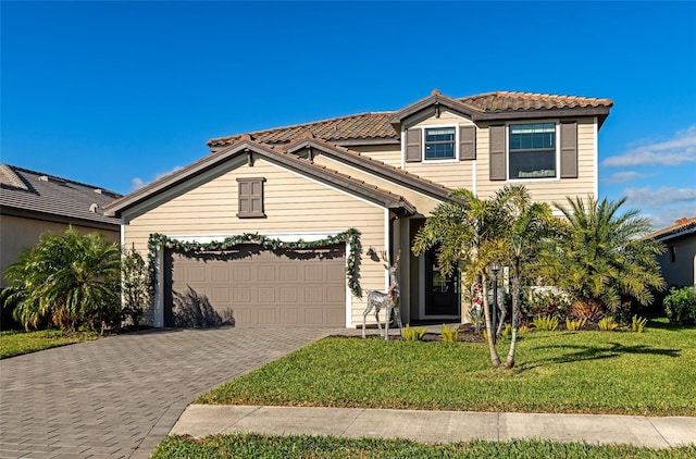 view of front of property with a front lawn and a garage