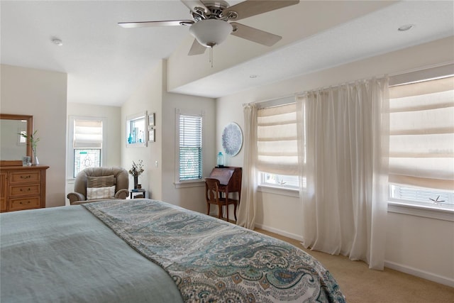 bedroom with vaulted ceiling, light colored carpet, and ceiling fan