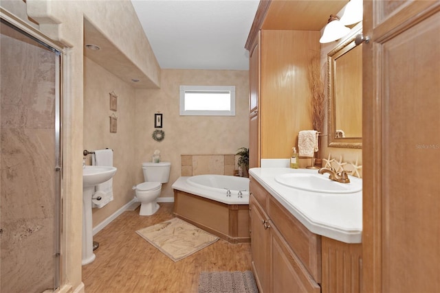 full bathroom with hardwood / wood-style flooring, plus walk in shower, sink, and toilet