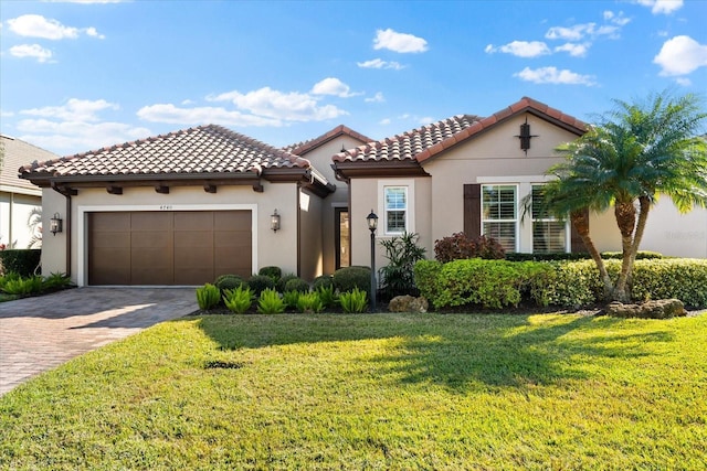 mediterranean / spanish-style home with a front yard and a garage