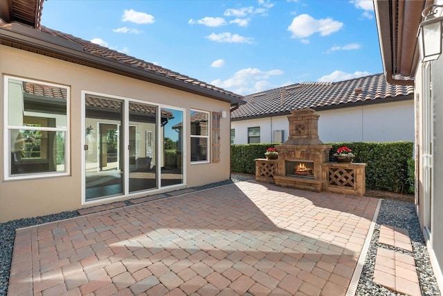 view of patio with an outdoor stone fireplace