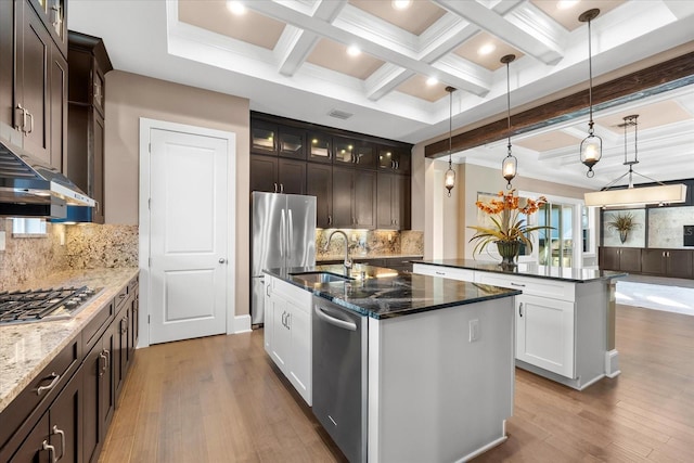 kitchen with hardwood / wood-style floors, a kitchen island with sink, decorative light fixtures, appliances with stainless steel finishes, and dark brown cabinets